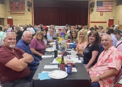 Table of smiling participants in gymnasium