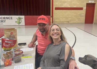 Table of smiling participants in gymnasium