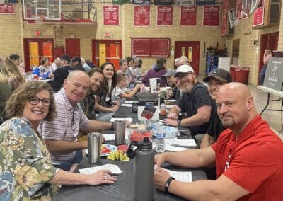 Table of smiling participants in gymnasium