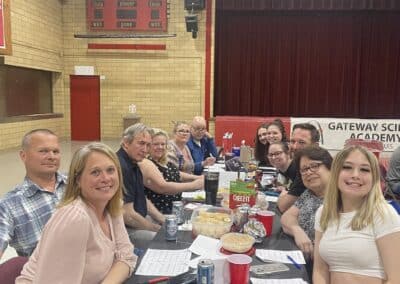 Table of smiling participants in gymnasium