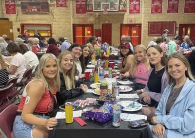 Table of smiling participants in gymnasium