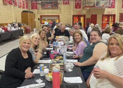 Table of smiling participants in gymnasium