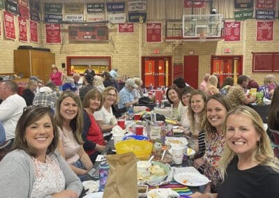 Table of smiling participants in gymnasium