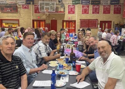 Table of smiling participants in gymnasium