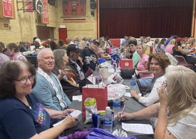 Table of smiling participants in gymnasium