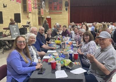 Table of smiling participants in gymnasium