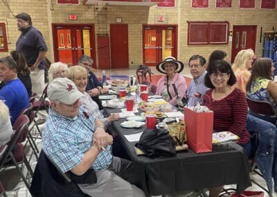 Table of smiling participants in gymnasium