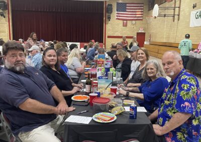 Table of smiling participants in gymnasium